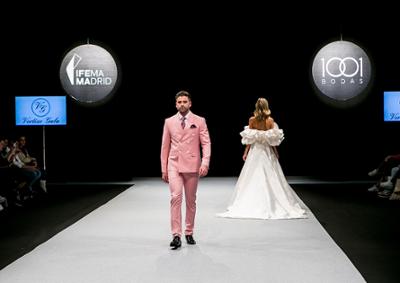 Man and woman parading on the 1001 Weddings catwalk.