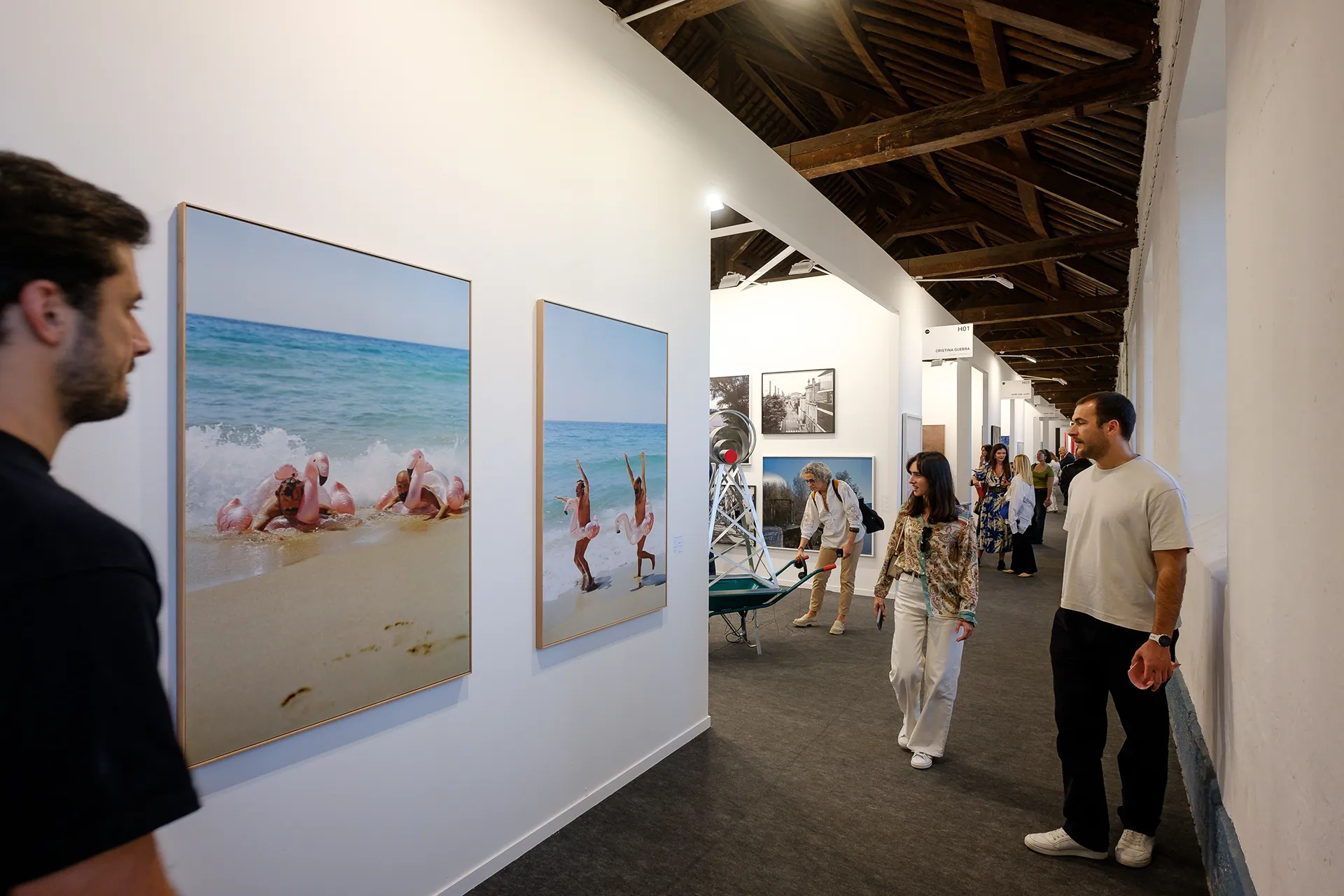 People looking at art paintings
