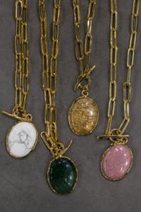 several pendants with golden chain and different gemstones