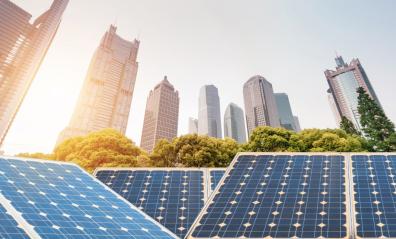 Background of different buildings of a city with solar panels at the base.
