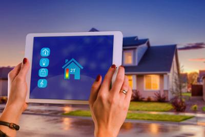 A person operating a tablet that controls the air conditioning in a house.