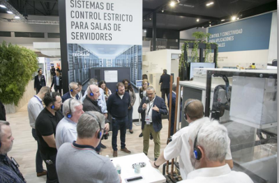 Stand with exhibitors talking.