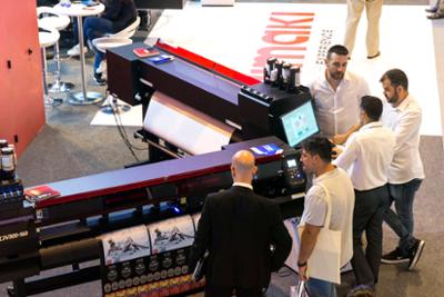 Visitors looking at an industrial printer.
