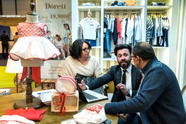 Meeting at a booth for baby clothes