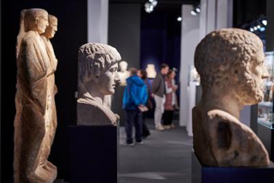 Exhibition room with paintings and sculptures.