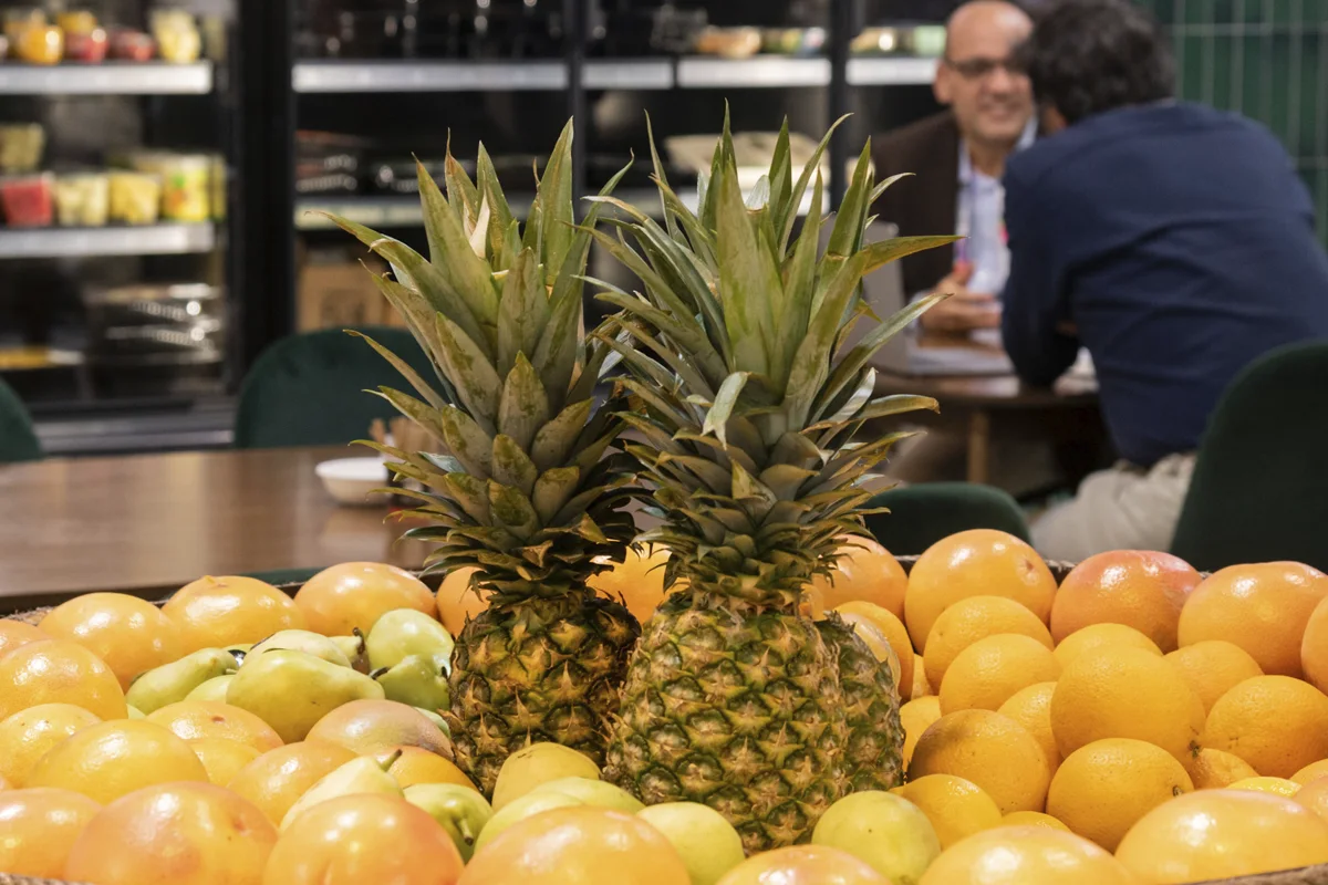 Orange stand with pineapples on top at Fruit Attraction