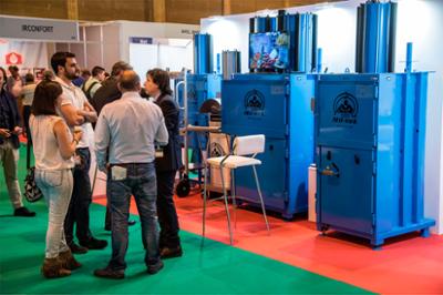 Visitors at a stand at the GENERA fair in IFEMA