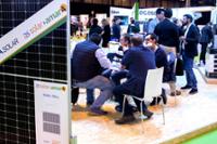 Stand de placas solares con visitantes reunidos.