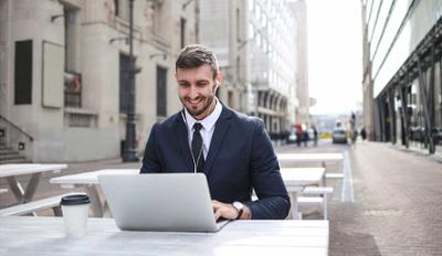 Man with a computer and headphones.