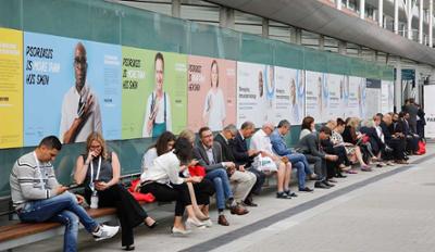 Visitors sitting on a wooden bench.