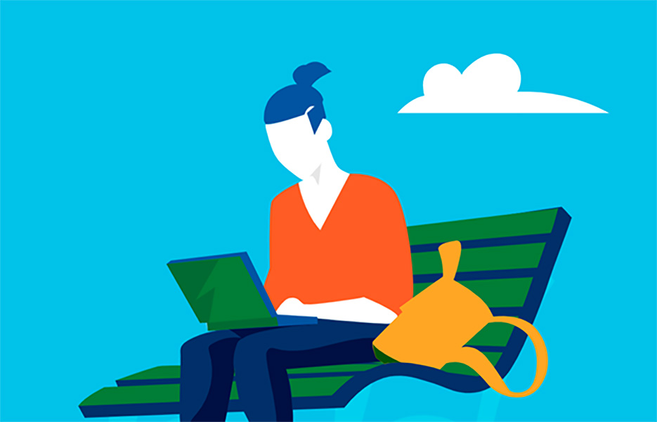 Woman sitting on bench and looking at laptop.