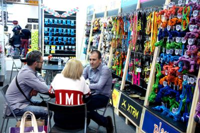 Visitors talking at a dog toy and leash stand