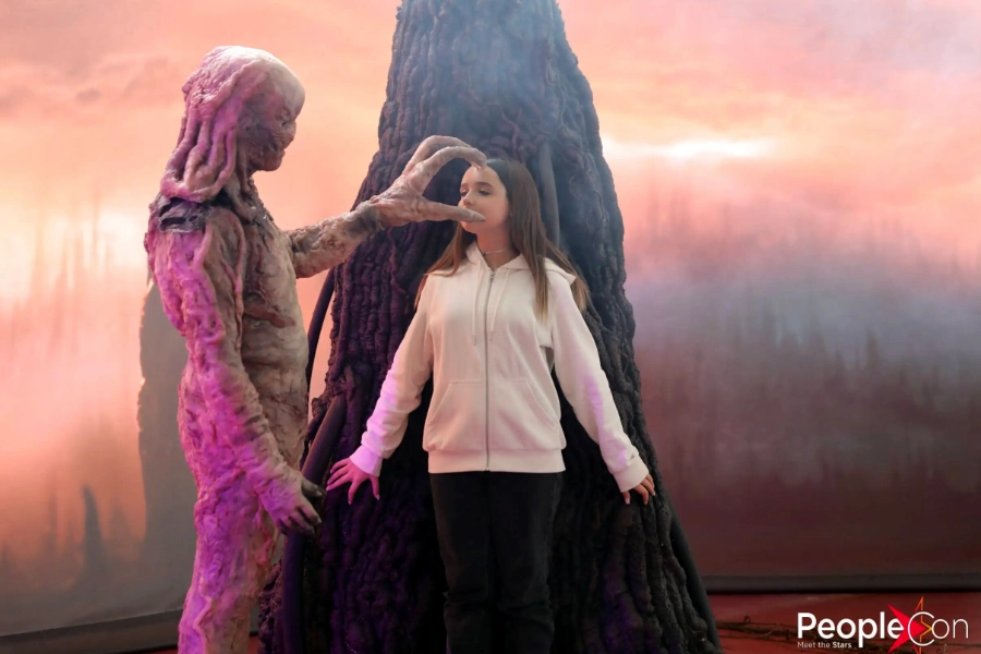 Girl posing with a Vecna figure at the Stranger Things event
