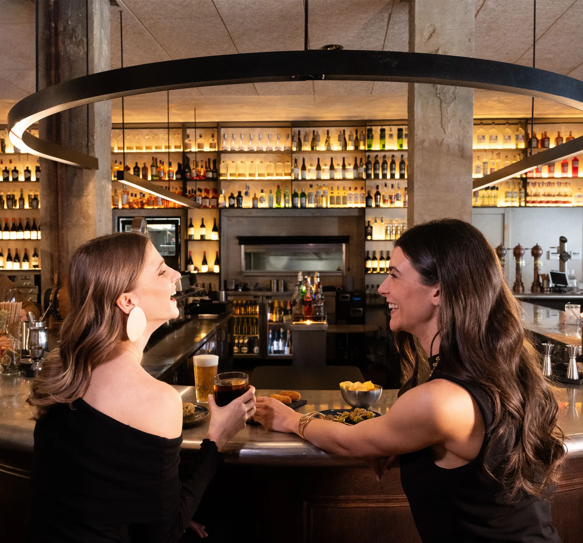 Two friends enjoying themselves in a bar