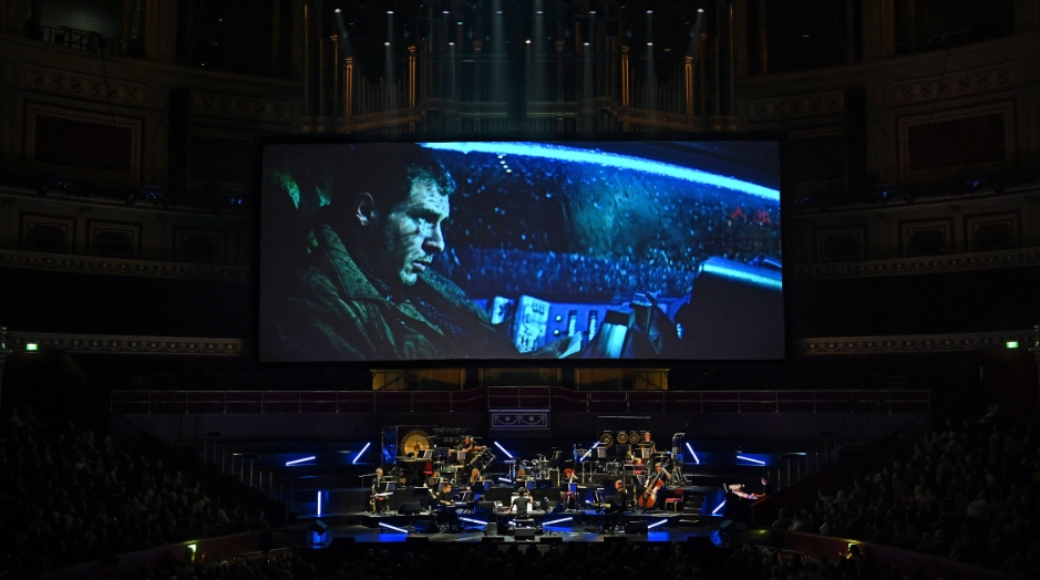 orquesta encima del escenario tocando musica de Blade Runner Live con escena de la película
