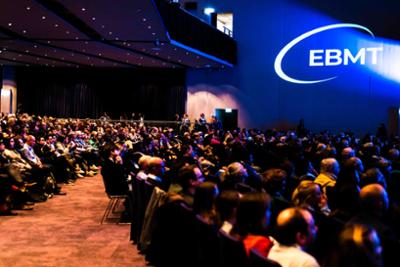 People listening to a presentation at EBMT