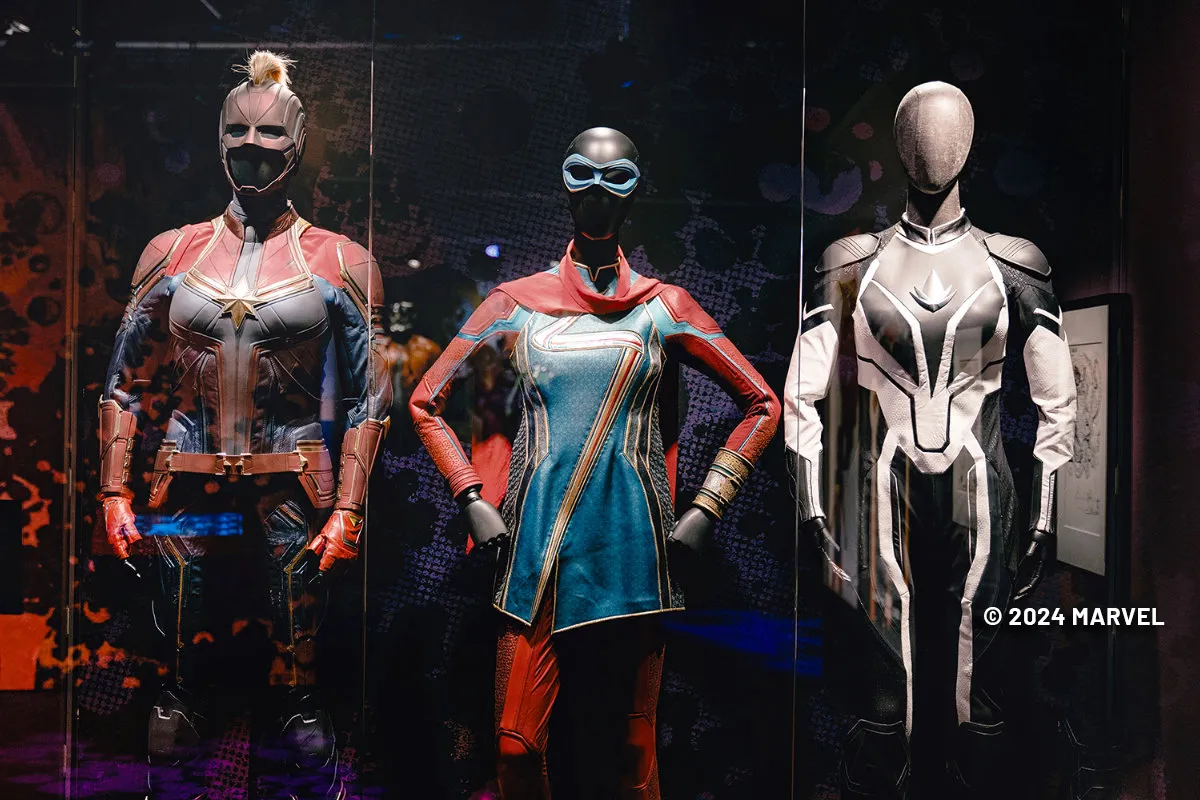 captain marvel, ms marvel and proton costumes at the marvel: Universe of Super Heroes exhibit