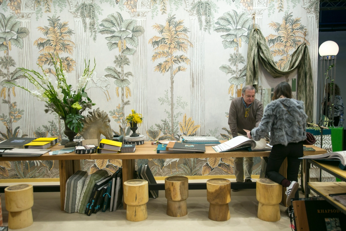 People looking at a sample book from Intergift Textile Publishers