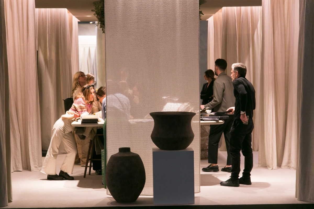 Visitors at the Textile Publishers stand at Intergift, surrounded by fabrics