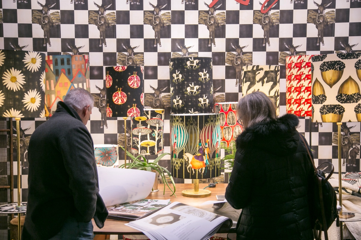 Visitors looking at an Intergift Textile Publishers stand displaying fabric samples