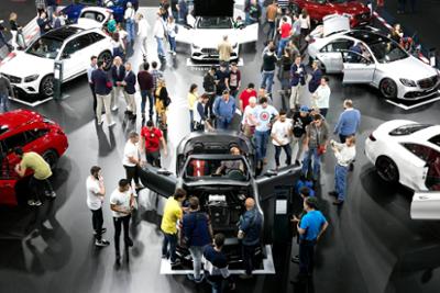 Visitors looking at cars exhibited.