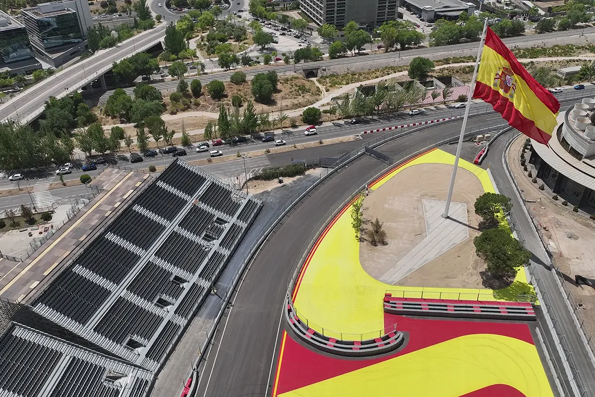 Spanish flag at a corner of the Madring Formula 1 circuit with spectator grandstands