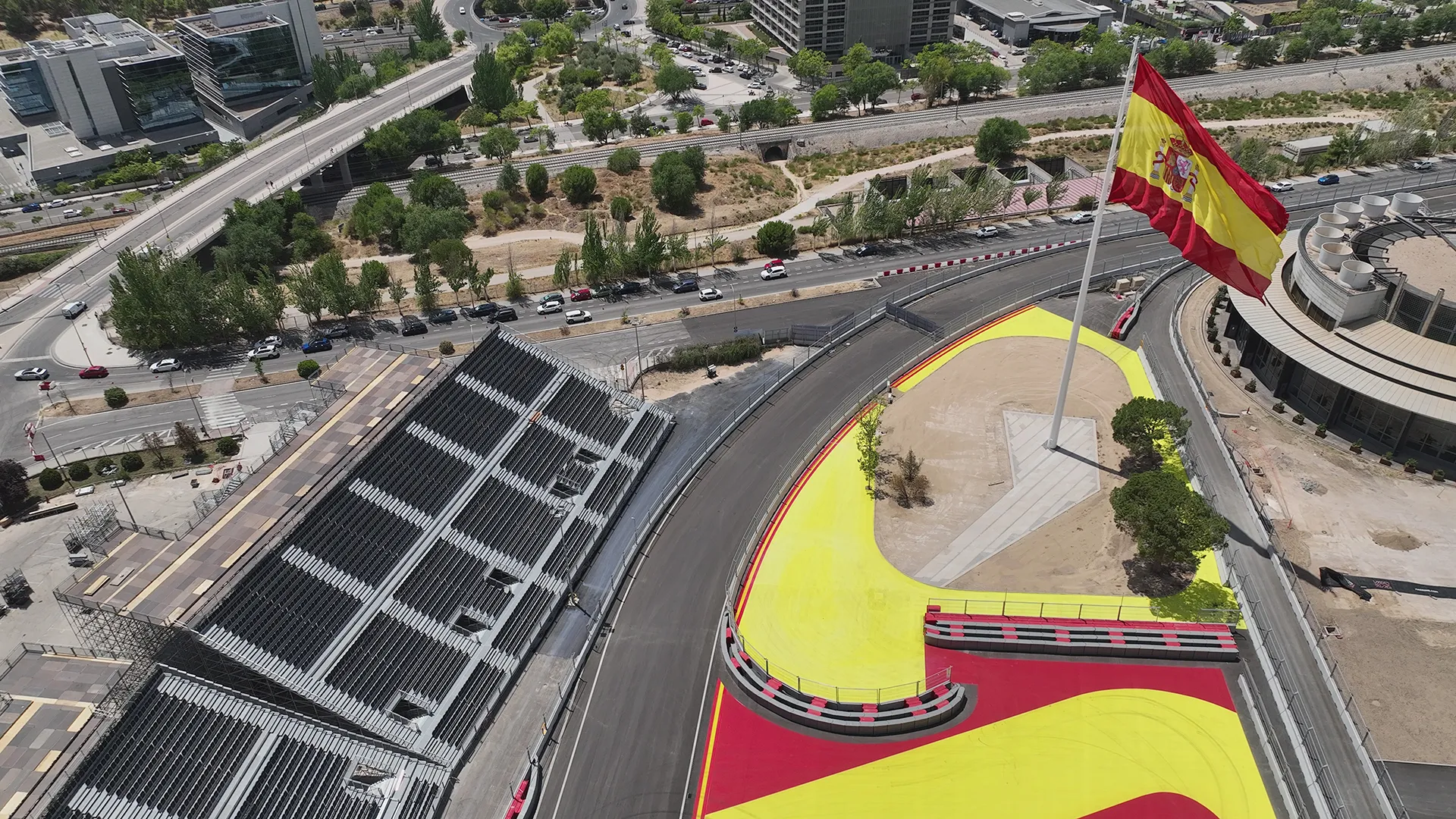 Spanish flag at a corner of the Madring Formula 1 circuit with spectator grandstands