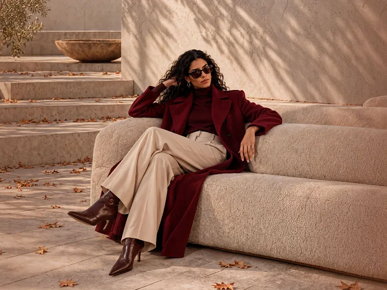 mujer elegante sentada en un sillón de diseño en una terraza con escalones en momad 2026