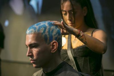 hairdresser combing a boy's hair