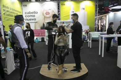 hairdresser cutting hair on stand