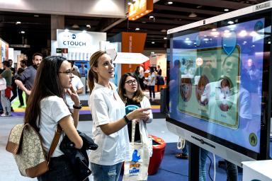 Visitors looking at interactive screen