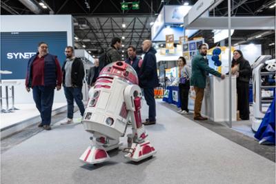 visitantes viendo un robot en simo educación