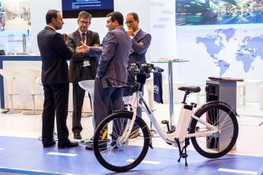 Professionals of the sector next to an electric bicycle