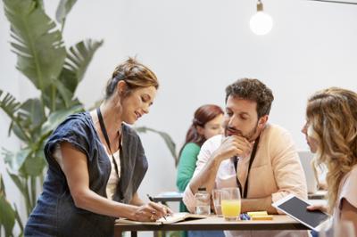 People studying a project at a table.