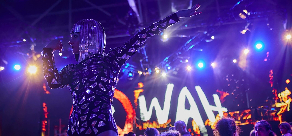 girl dancing in front of the wah logo
