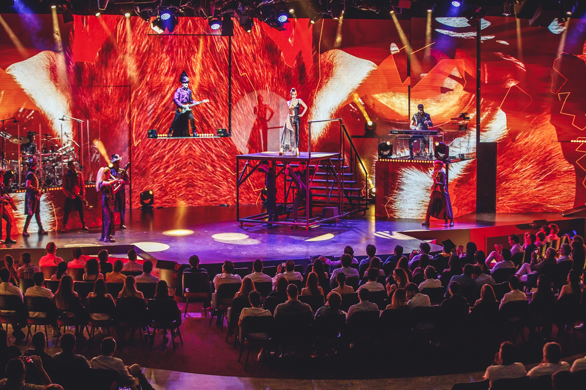 WAH show with red lights and performers on stage